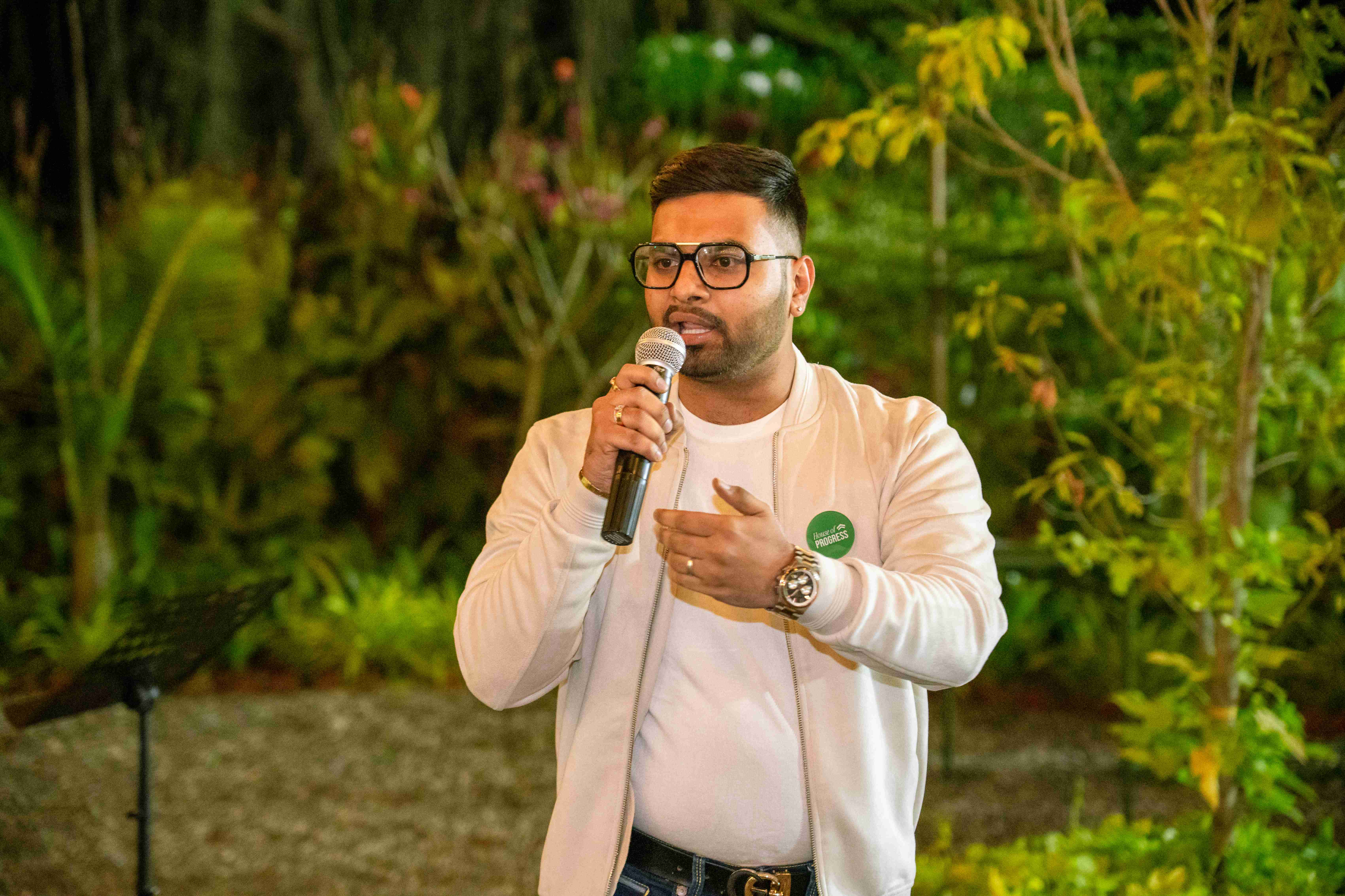 House of Progress member speaking with badge