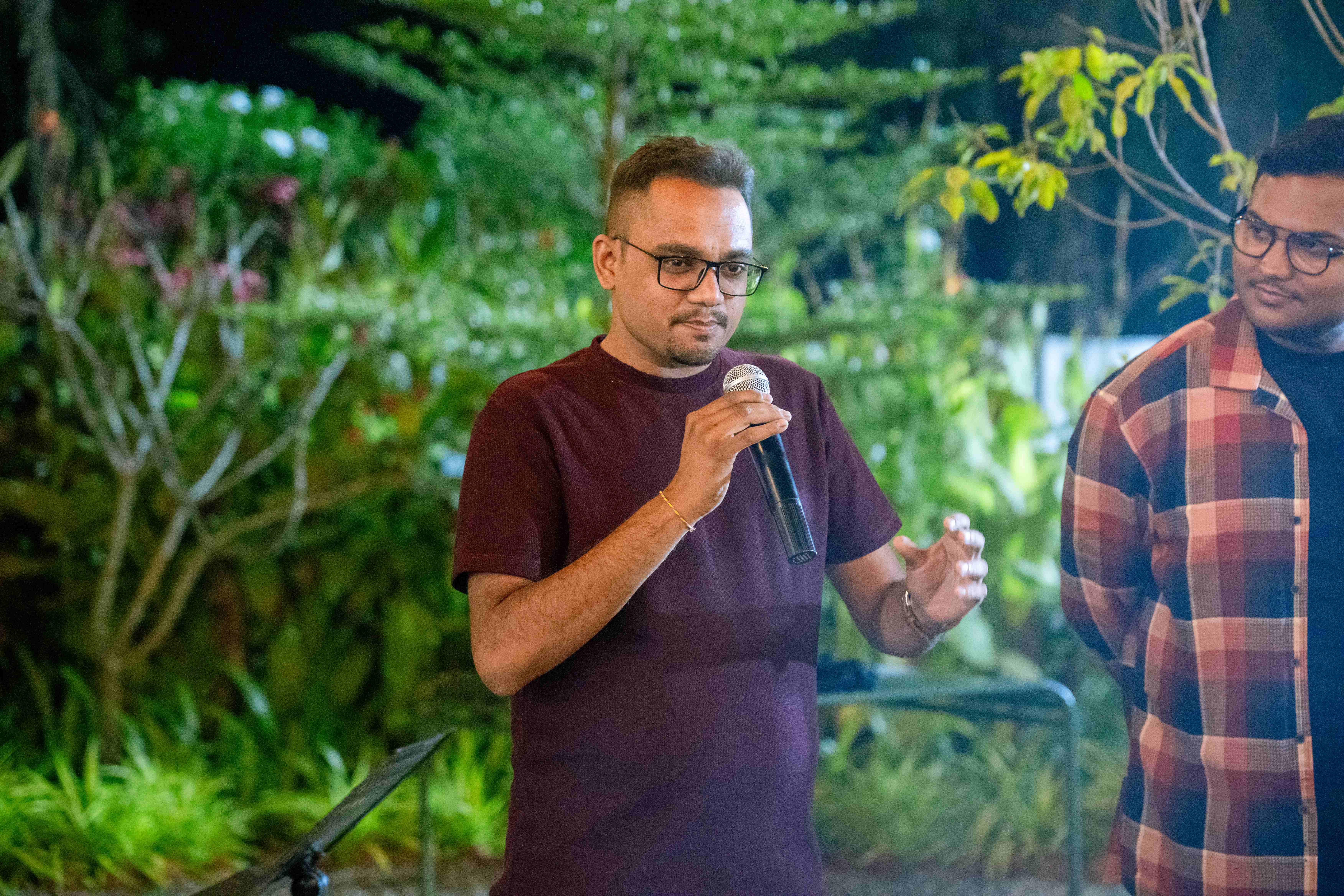 Speaker presenting at House of Progress outdoor event